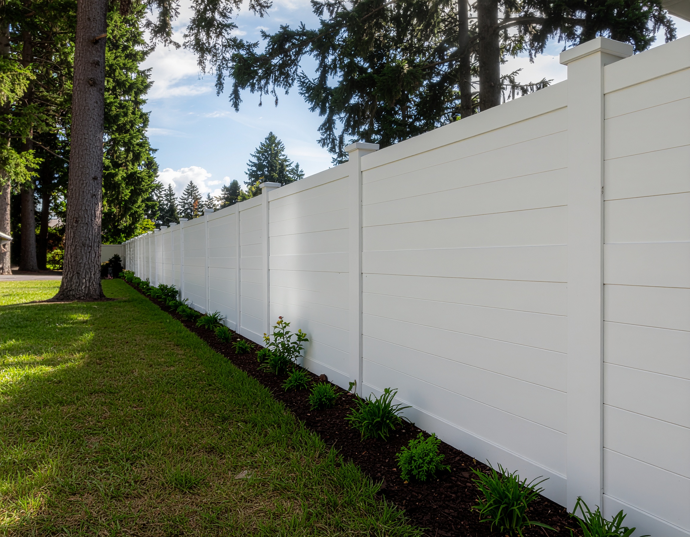 backyard bordered by a white vinyl privacy fence with tall smooth panels framed by 333287 - San Antonio Deck and Fence Works White vinyl privacy fence panels-deck builder-San Antonio, Texas