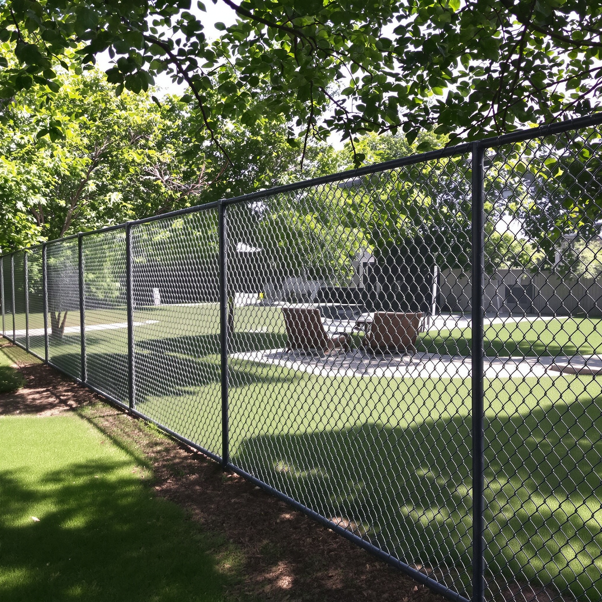 Chain-link fence with green lawn.-deck builder-San Antonio, Texas