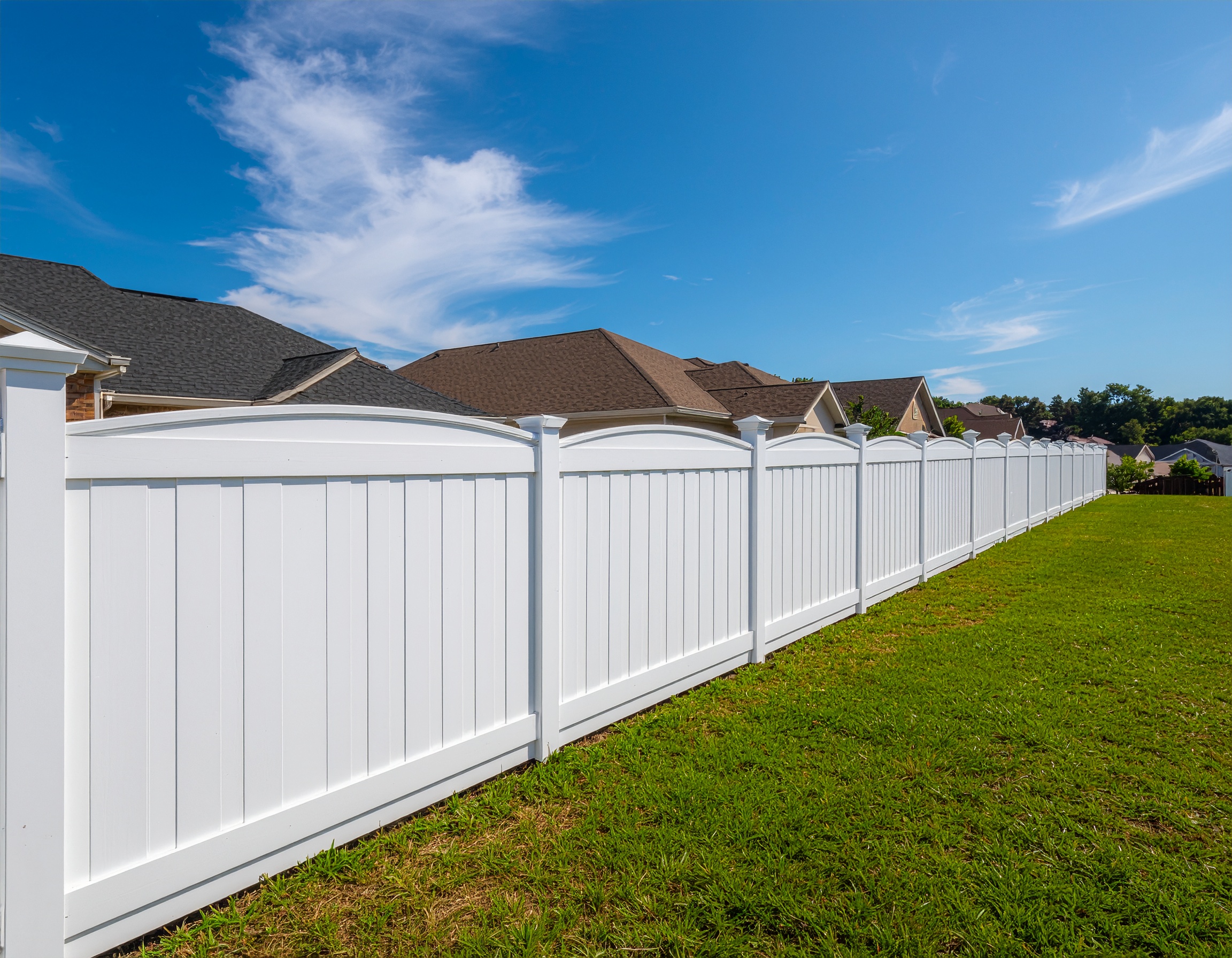 suburban yard bordered by a white vinyl picket fence with evenly spaced vertical sl 333287 - San Antonio Deck and Fence Works